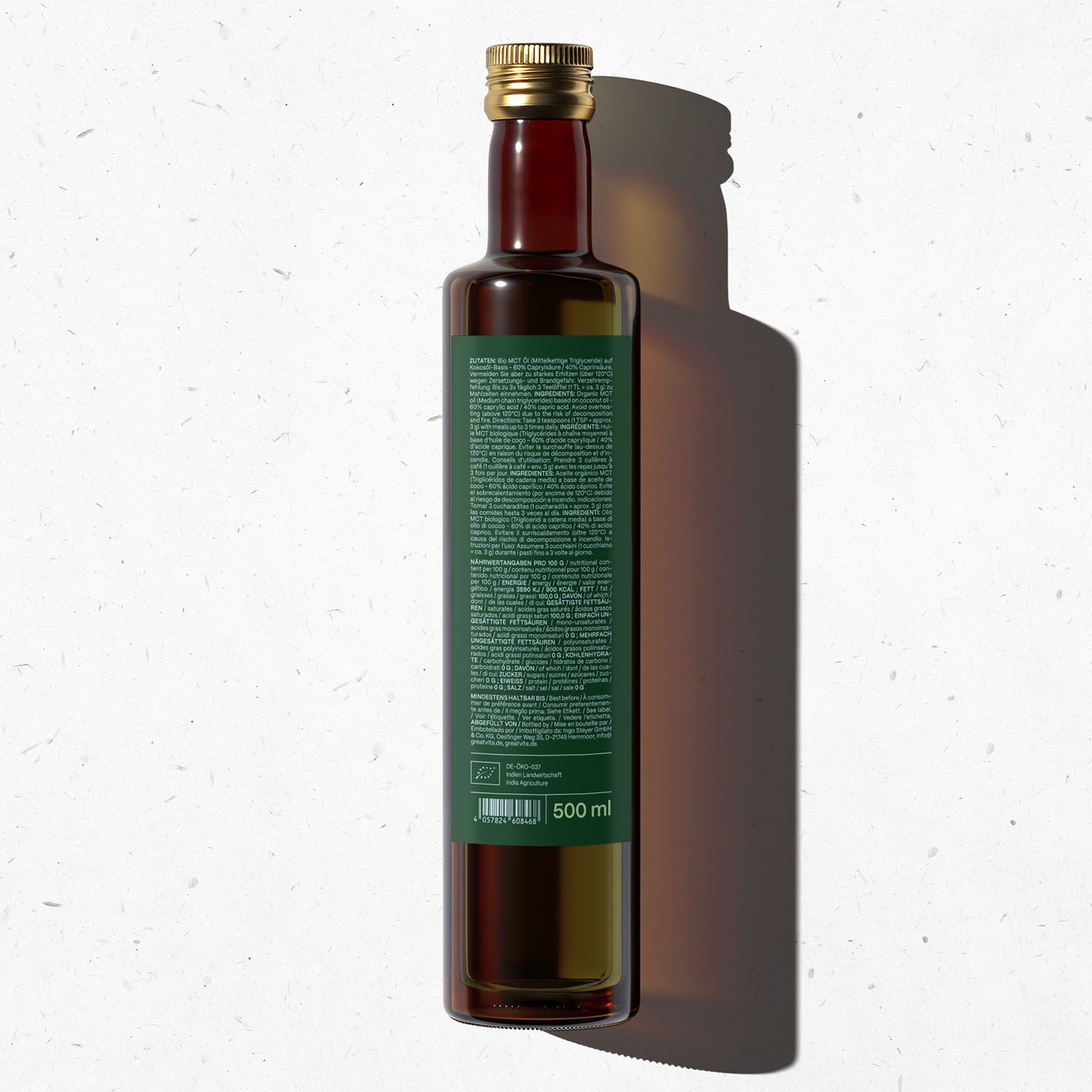 Braune Glasflasche mit grünem Etikett. Rückseite mit Text. Aufschrift: 500 ml. Goldfarbener Verschluss.