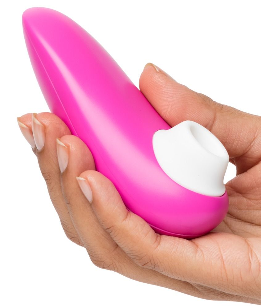 Ein pinker Vibrator mit weißer Spitze, gehalten in einer Hand.