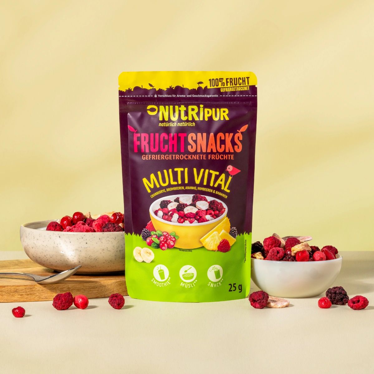 Zwei Schalen mit gefriergetrockneten Früchten und eine Tüte NutriPur Frucht Snacks. Auf einem Holzbrett.