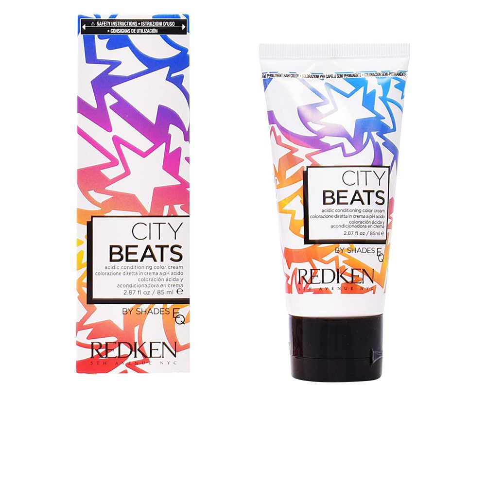 Farbcreme-Tube und Schachtel. Aufdruck: CITY BEATS, REDKEN. Farbverlauf-Design mit Sternen. Schwarzer Tubenverschluss.