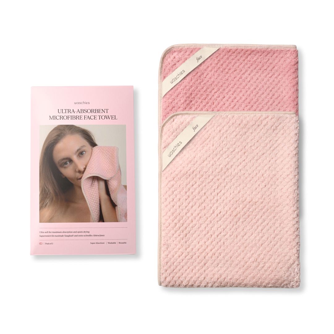 Verpackung und zwei rosa Mikrofasertücher. Text: Ultra saugstarkes Mikrofaser Face Towel. Waschies.