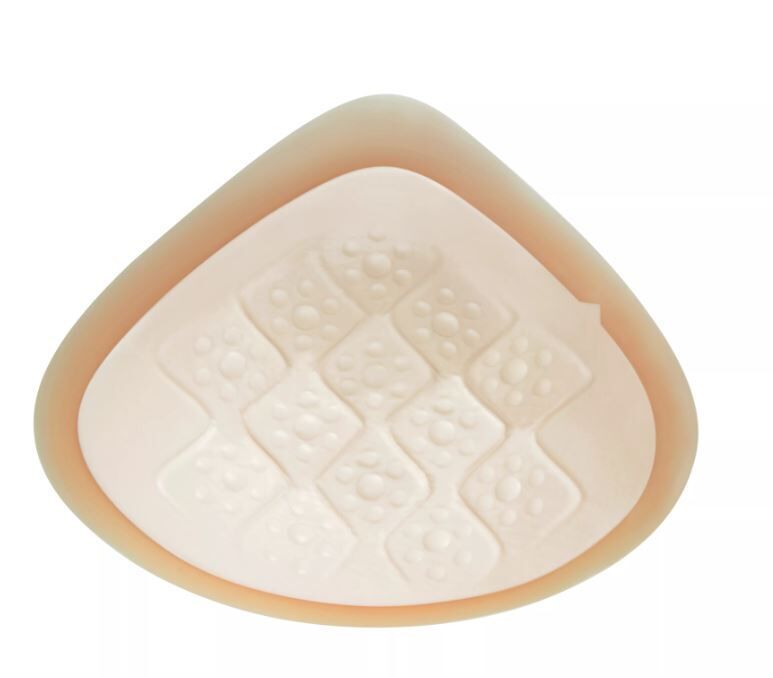 Beige Ausgleichsepithese. Dreieckige Form mit quadratischem Muster auf der Oberfläche.