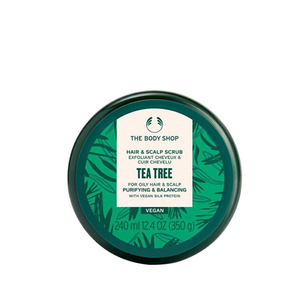Grüne Dose mit weißem Etikett. Aufschrift: THE BODY SHOP, Hair & Scalp Scrub, Tea Tree. Vegan. 240 ml. Draufsicht.