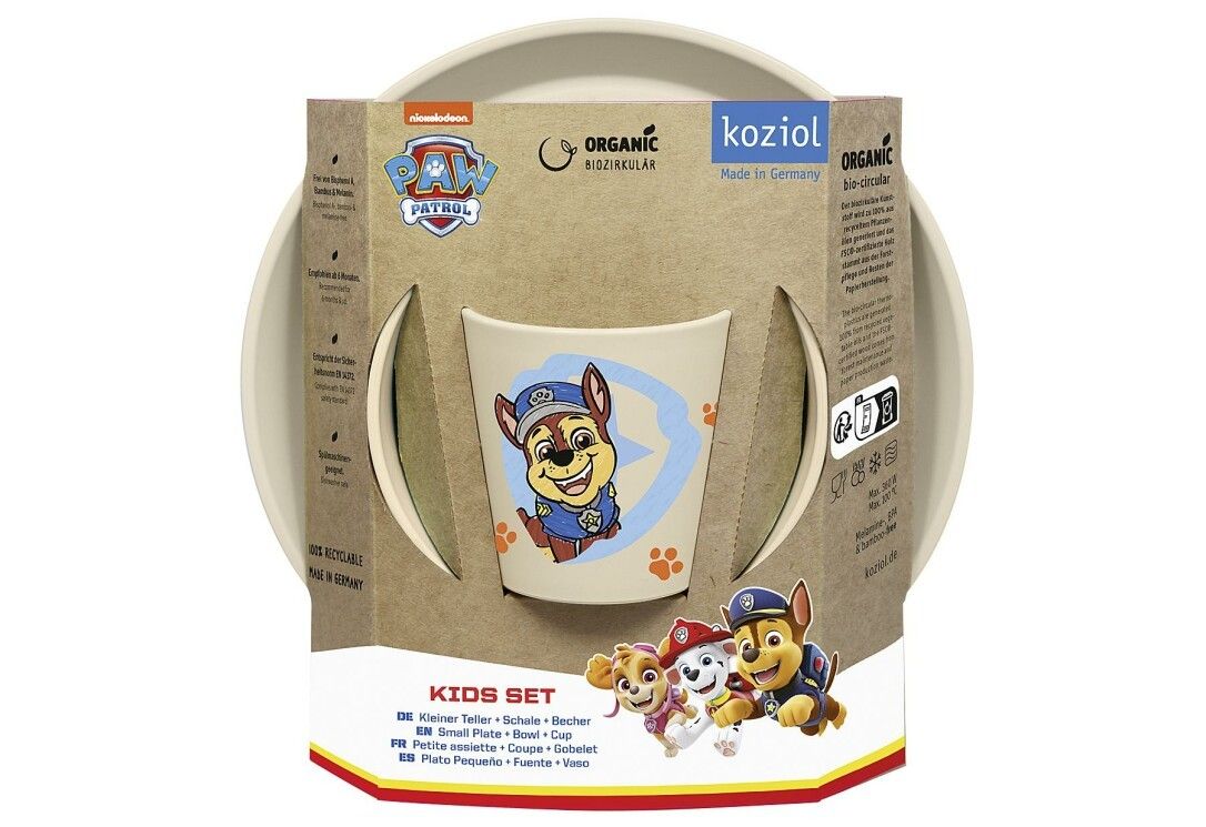Verpackung des Kindergeschirr-Sets. Enthält eine Schüssel, einen Becher und einen Teller. Mit Paw Patrol-Motiven. Marke: KOZIOL.