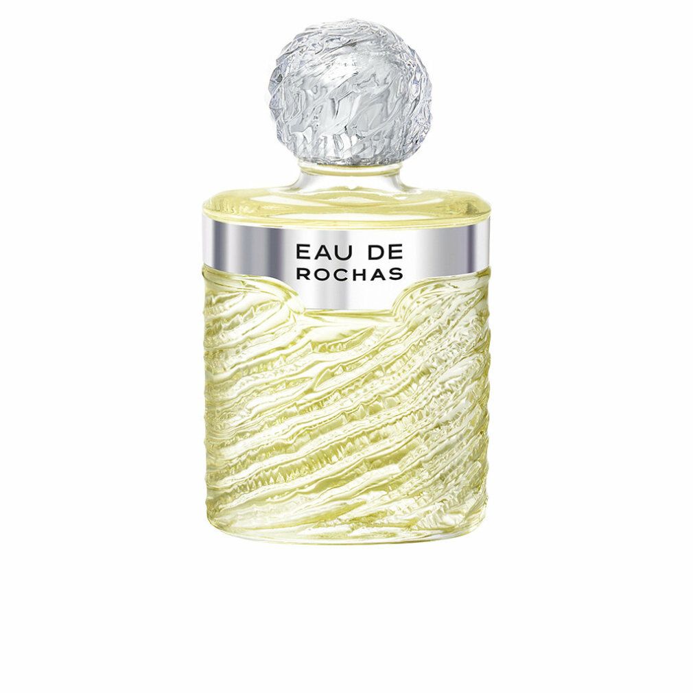 Parfümflasche mit silbernem Band, Aufschrift "EAU DE ROCHAS". Klarglasflasche mit wellenförmiger Textur. Kugelverschluss.