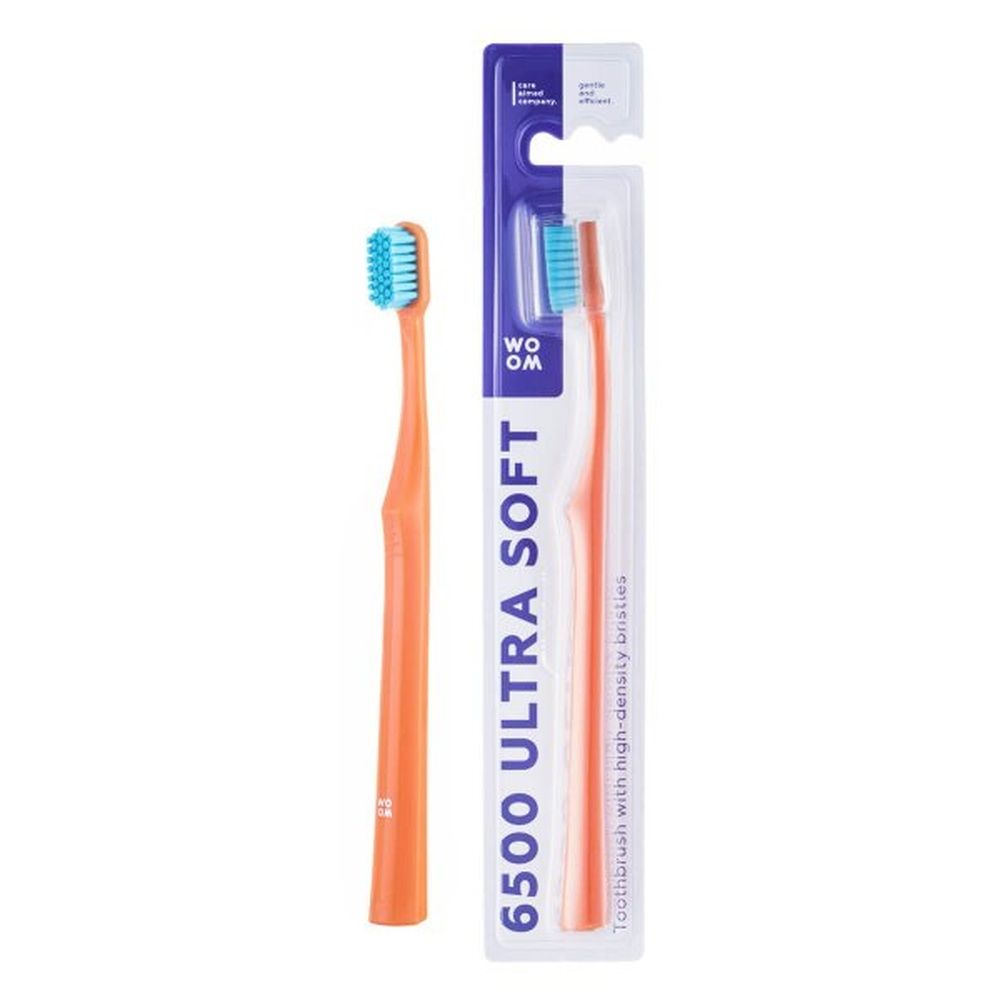 Orangefarbene Zahnbürste und Verpackung. Auf der Verpackung steht '6500 ULTRA SOFT'.
