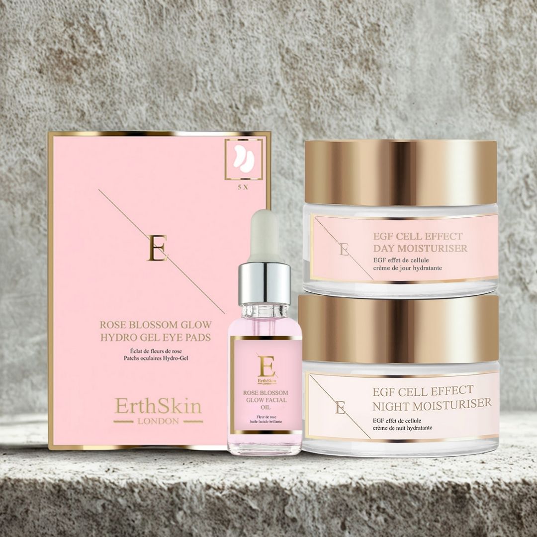 Set mit Augenpads, Gesichtsöl und zwei Cremes. Rosa und goldfarbene Verpackung. Beschriftung: EGF Cell Effect, Day Moisturiser, Night Moisturiser. Text: ErthSkin London.