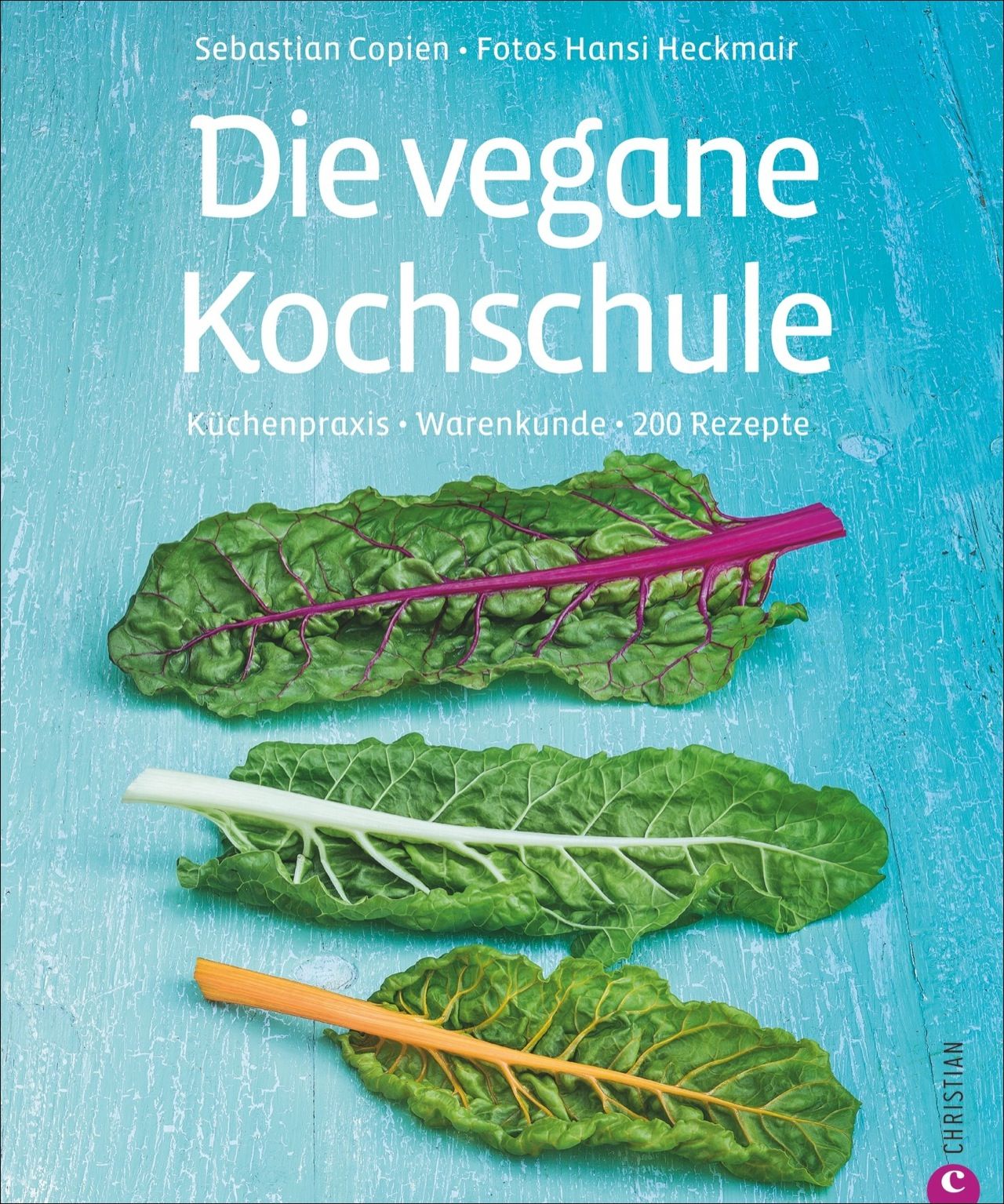 Buchcover: "Die vegane Kochschule". Titel in Weiß. Autoren: Sebastian Copien, Fotos Hansi Heckmair. Grüne Blätter auf blauem Hintergrund.