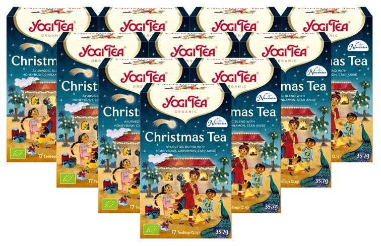 Mehrere Packungen Yogi Tea Christmas Bio Gewürztee. Blaue Verpackung mit Illustrationen und Logo. 17 Beutel.