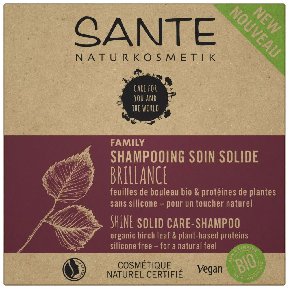Kartonverpackung mit Produktinformationen, Logo und Zertifizierungen. Text: Shampooing Soin Solide Brillance.