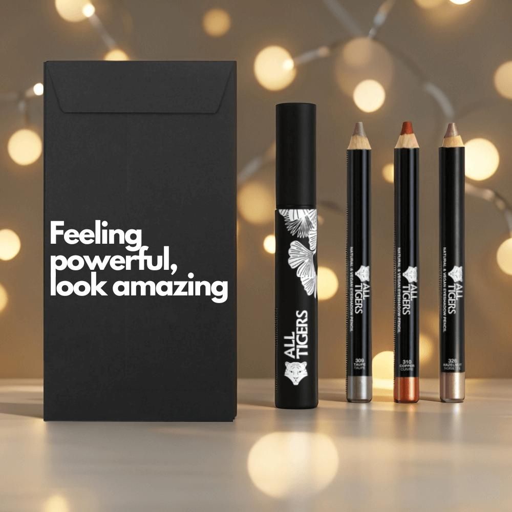 Schwarze Verpackung mit Text. Mascara und drei Augenstifte. Marke ALL TIGERS.