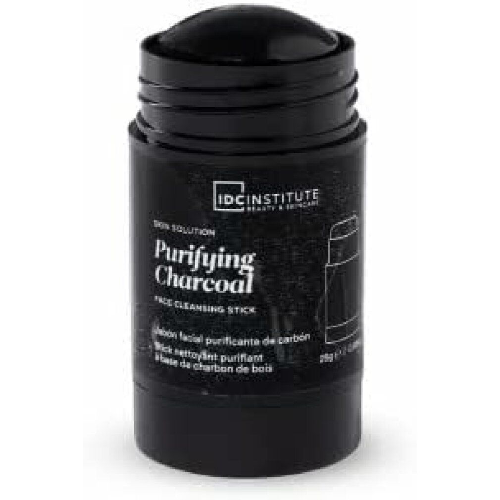 Schwarzer Reinigungsstick. Aufschrift: Purifying Charcoal, IDC INSTITUTE. Zylinderförmige Verpackung.