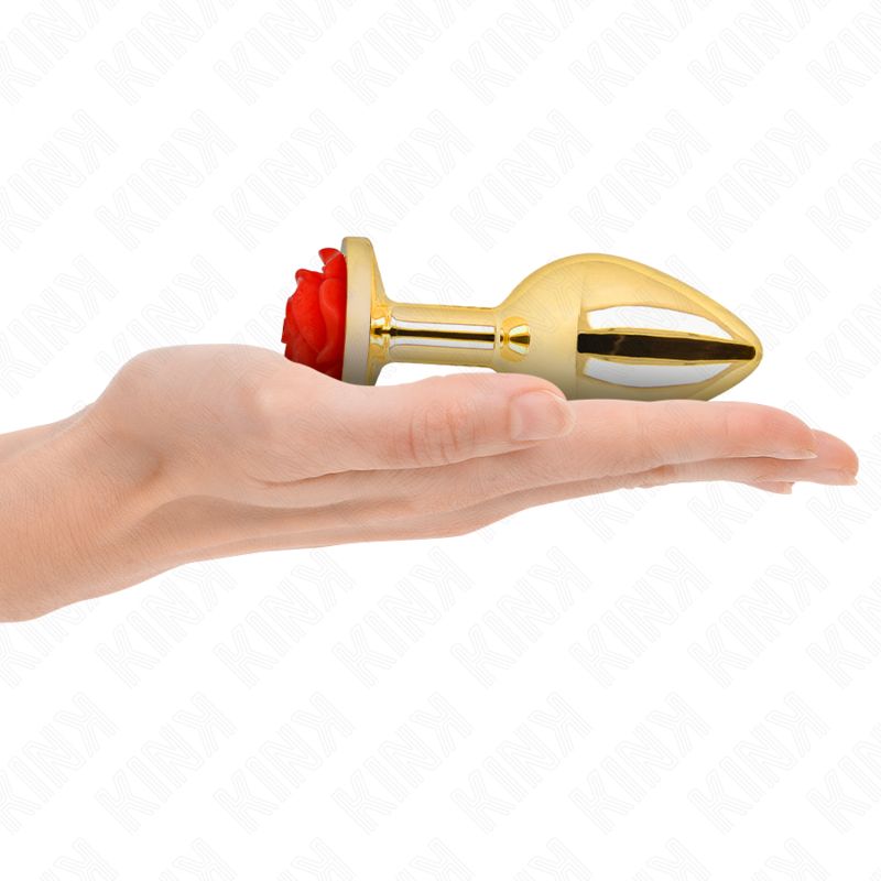 Goldener Analplug mit roter Rose in einer Hand.