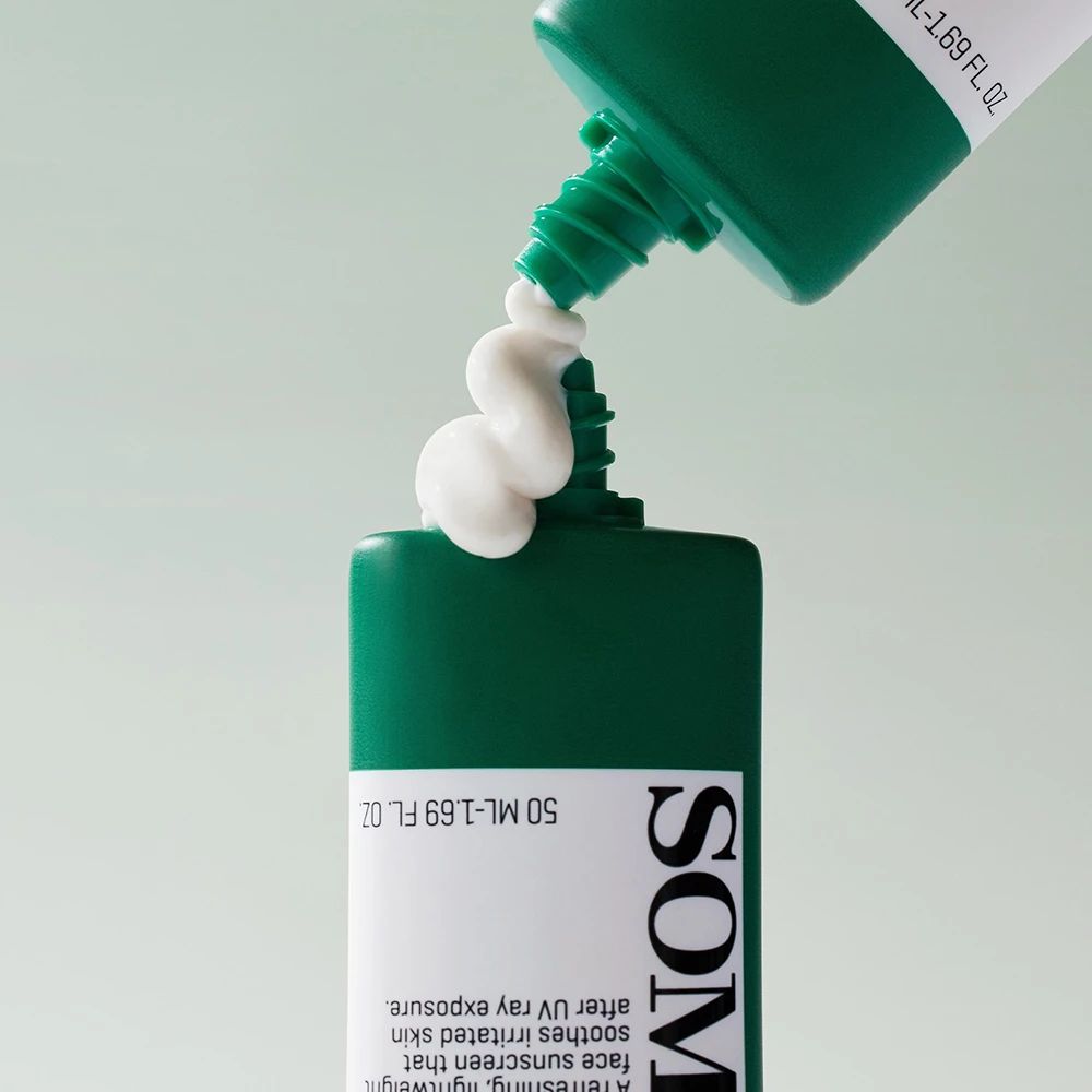 Grüne Tube, aus der Sonnencreme austritt. Text: SOMEBYMI. Aufschrift: 50 ML - 1.69 FL. OZ. Creme ist weiß.