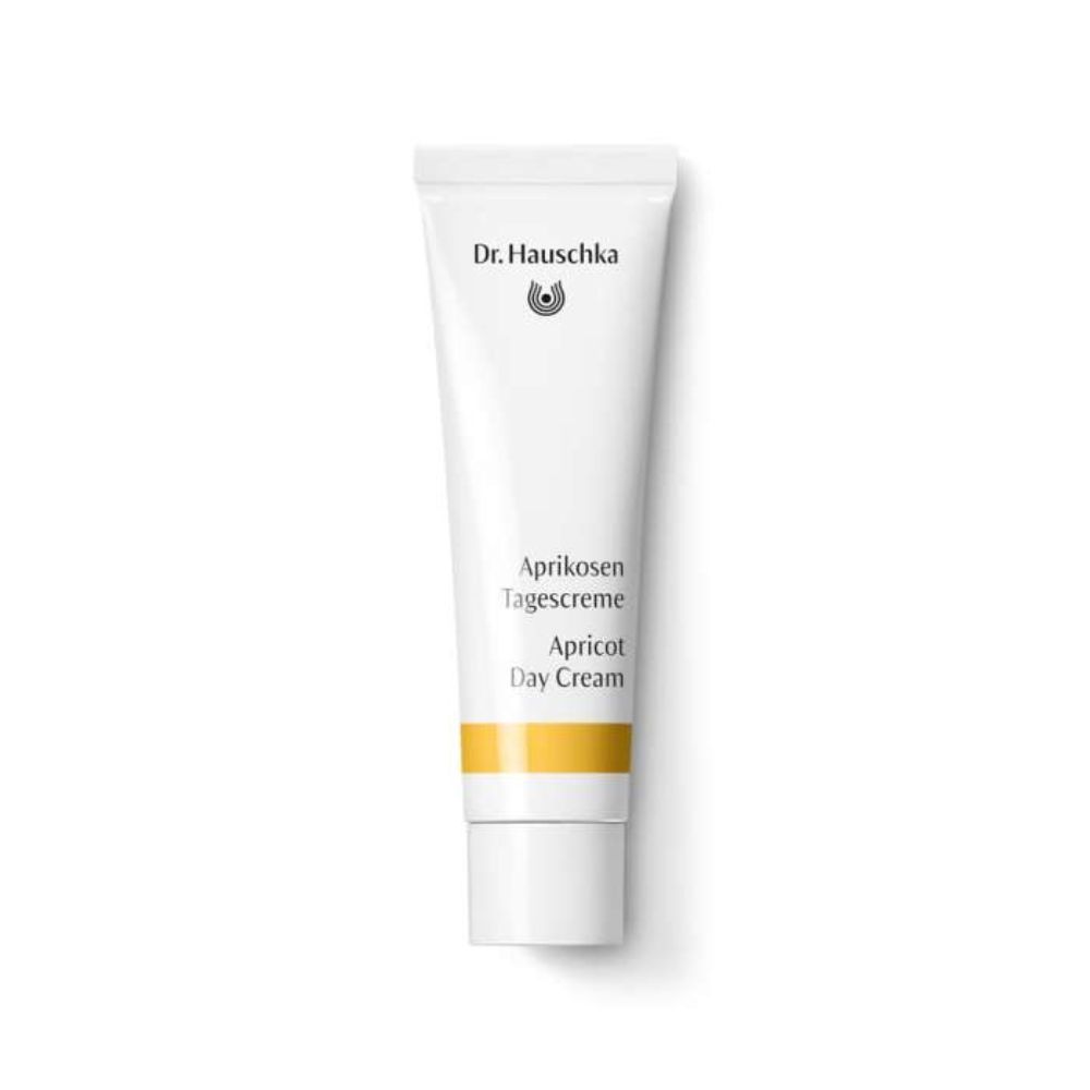 Weiße Tube mit gelbem Streifen. Beschriftung: Dr. Hauschka, Aprikosen Tagescreme, Apricot Day Cream.