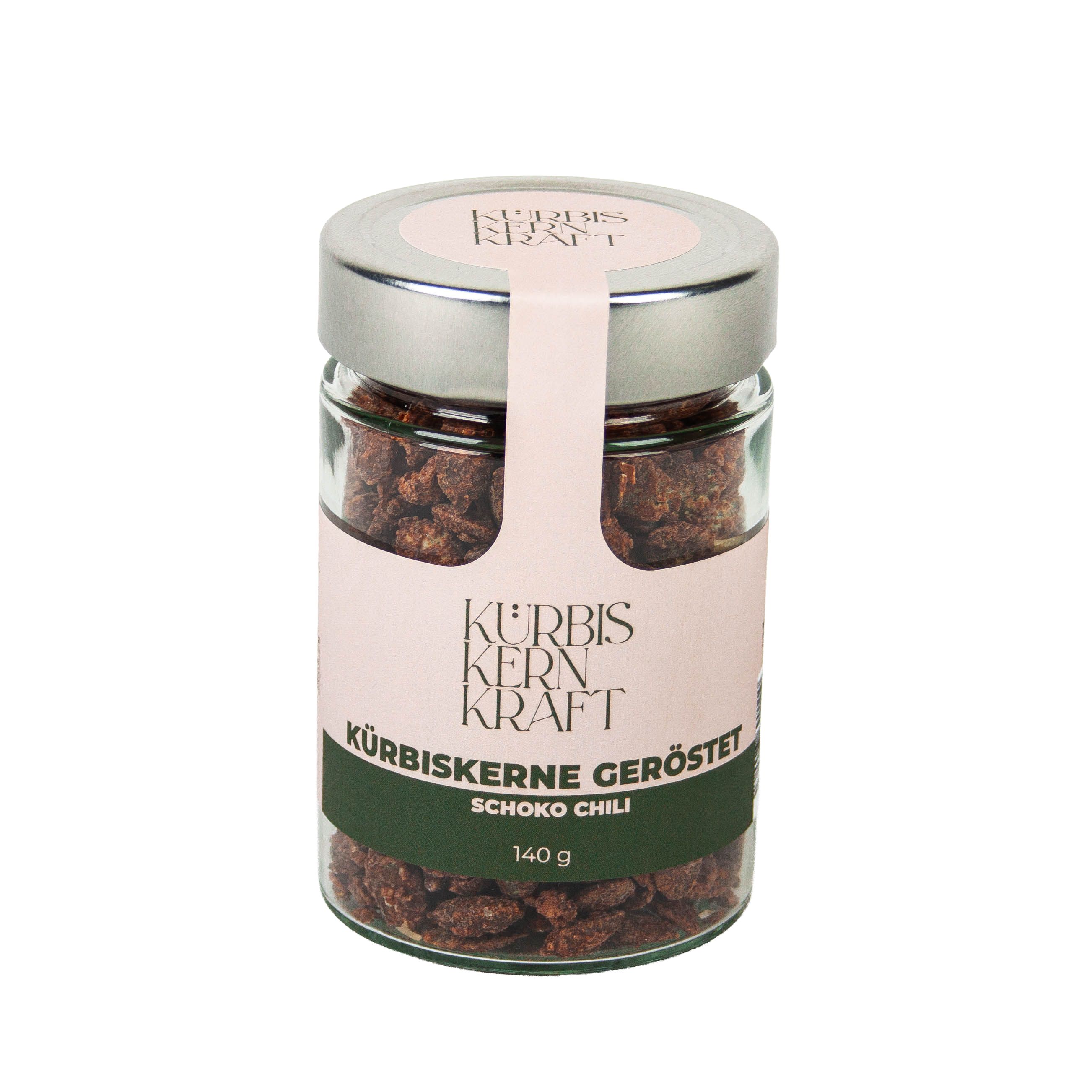 Glas mit gerösteten Kürbiskernen Schoko-Chili. Etikett mit Produktname und Marke. 140g.