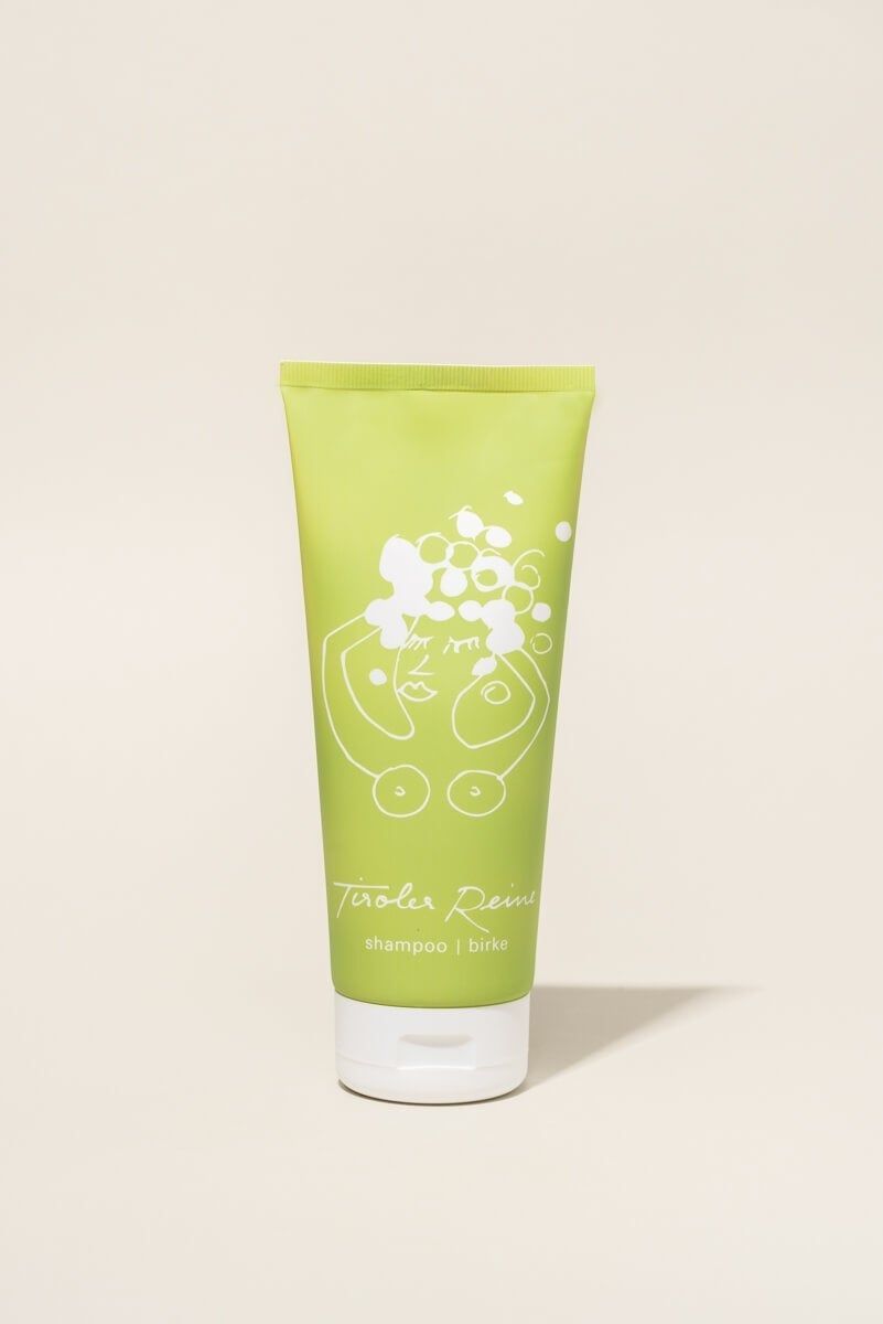 Grüne Tube mit weißer Illustration und Schriftzug Tiroler Reine Shampoo Birke. Weißer Verschluss.