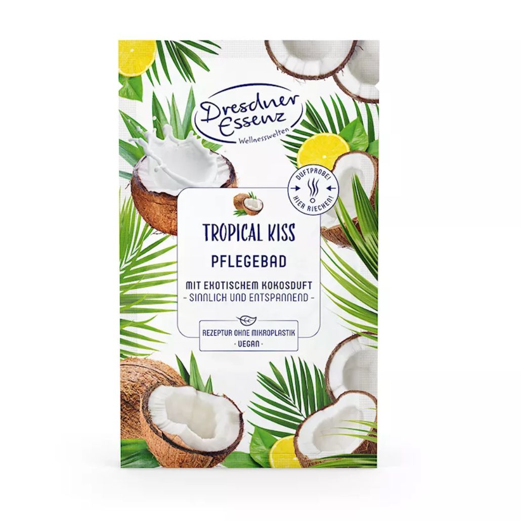 Verpackung von Dresdner Essenz Pflegebad Tropical Kiss. Kokosnuss- und Zitronen-Illustrationen. Text: Tropical Kiss, Pflegebad, mit exotischem Kokosduft.