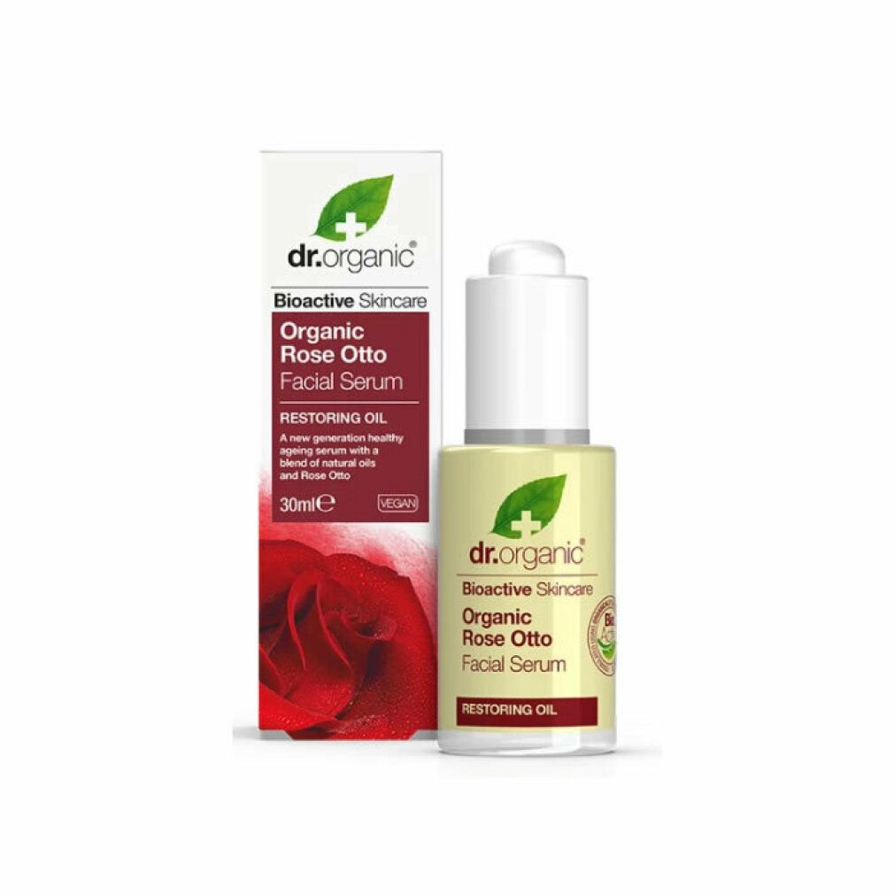 Serumflasche und Verpackung. Aufschrift: Dr. Organic, Organic Rose Otto Facial Serum. Rote Rose auf der Verpackung.