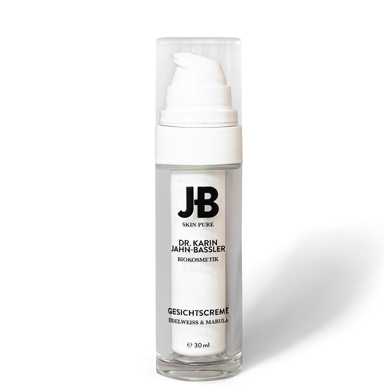 Gesichtscreme-Spender mit transparentem Gehäuse und weißem Pumpkopf. Aufschrift: JB SKIN PURE, DR. KARIN JAHN-BASSLER, GESICHTSCREME, 30 ml.