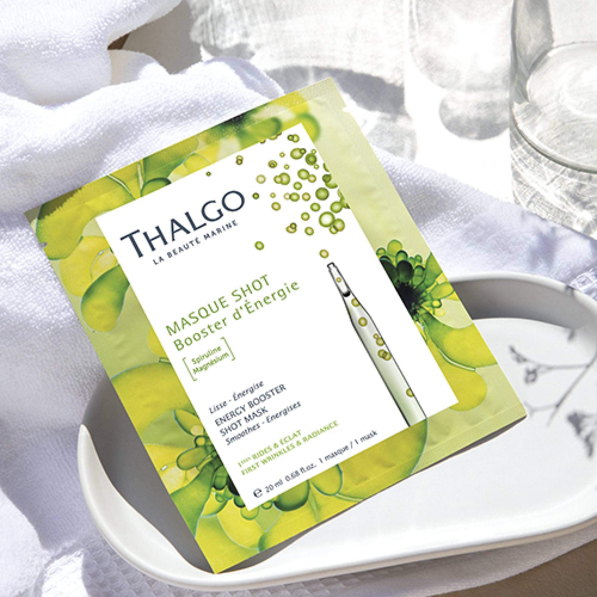 THALGO Maskenverpackung auf weißem Handtuch und Teller. Grün-weißes Design mit Produktinformationen und Ampullen-Illustration.