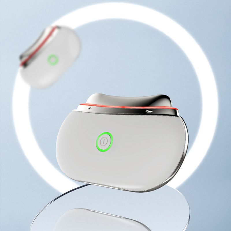 Zwei weiße LED Gua Sha Lifting-Geräte vor einem leuchtenden Ring. Eines schwebt.
