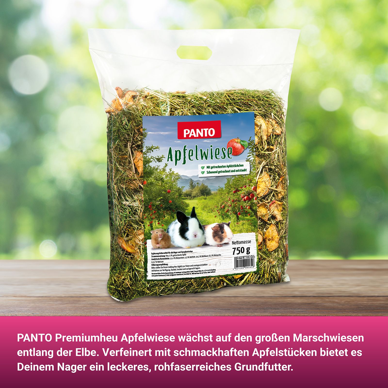 PANTO Apfelwiese Packung. Logo, Apfelabbildung. 750g. Auf Holztisch. Text: Premiumheu, Apfelstücke, Rohfaser.