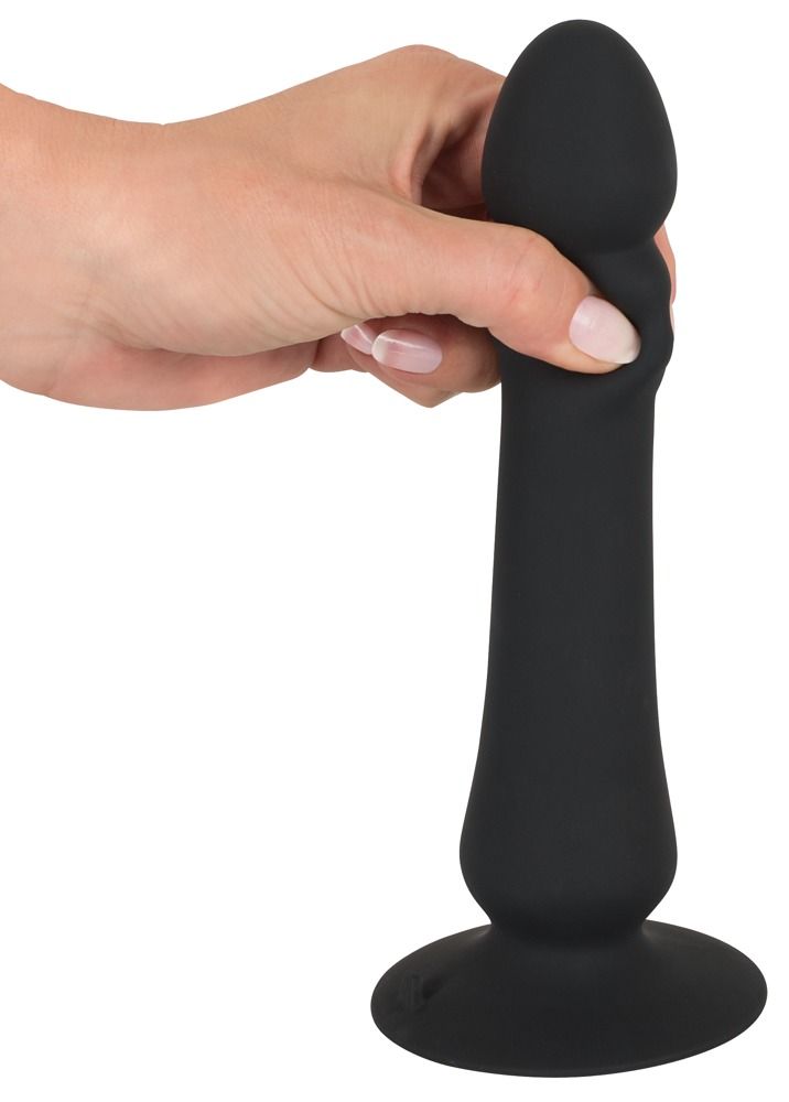 Schwarzer Anal Thruster, gehalten von einer Hand. Konische Form mit abgerundeter Spitze und breiter Basis.