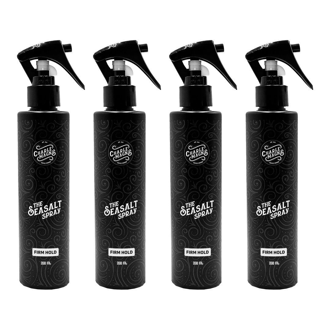 Vier schwarze Sprühflaschen mit "The Seasalt Spray" und "Firm Hold" Aufschrift.