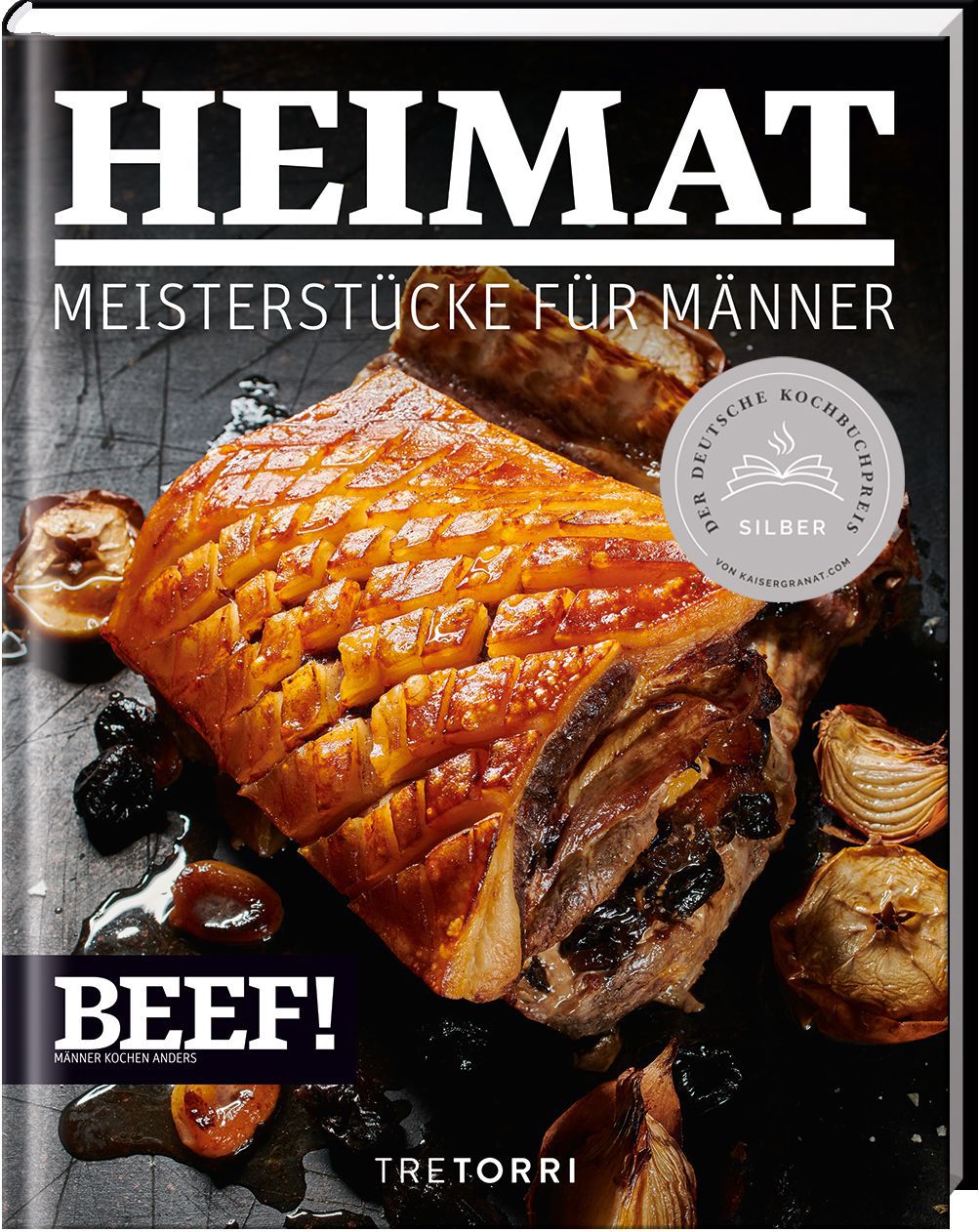 Kochbuch HEIMAT, Meisterstücke für Männer. Auf dem Cover: gebratenes Fleisch, Zwiebeln, Pflaumen. Auszeichnung: Silber.