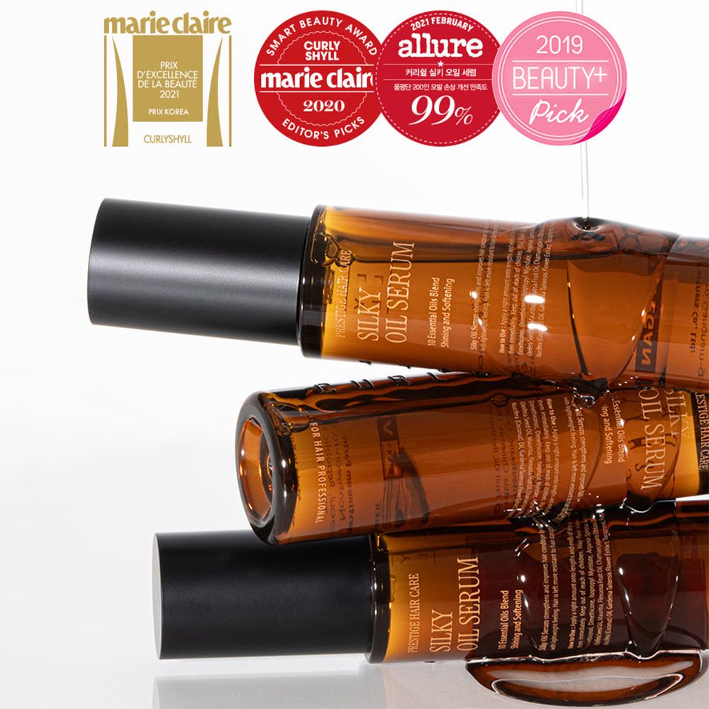 Drei braune Haarölflaschen mit schwarzen Deckeln. Auf den Flaschen steht Silky Oil Serum. Mehrere Auszeichnungen.