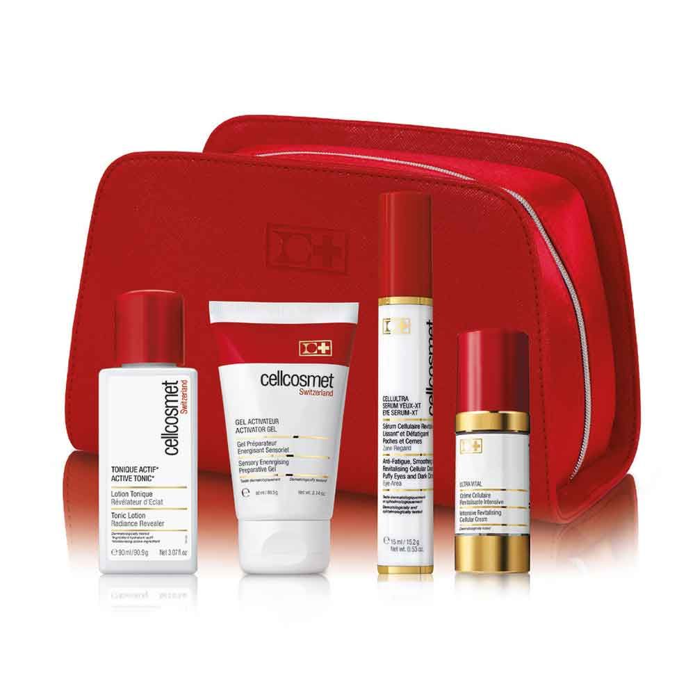 Rotes Kosmetiktäschchen mit vier Cellcosmet-Produkten. Enthält Flaschen und Tuben mit roter und goldener Akzentuierung.