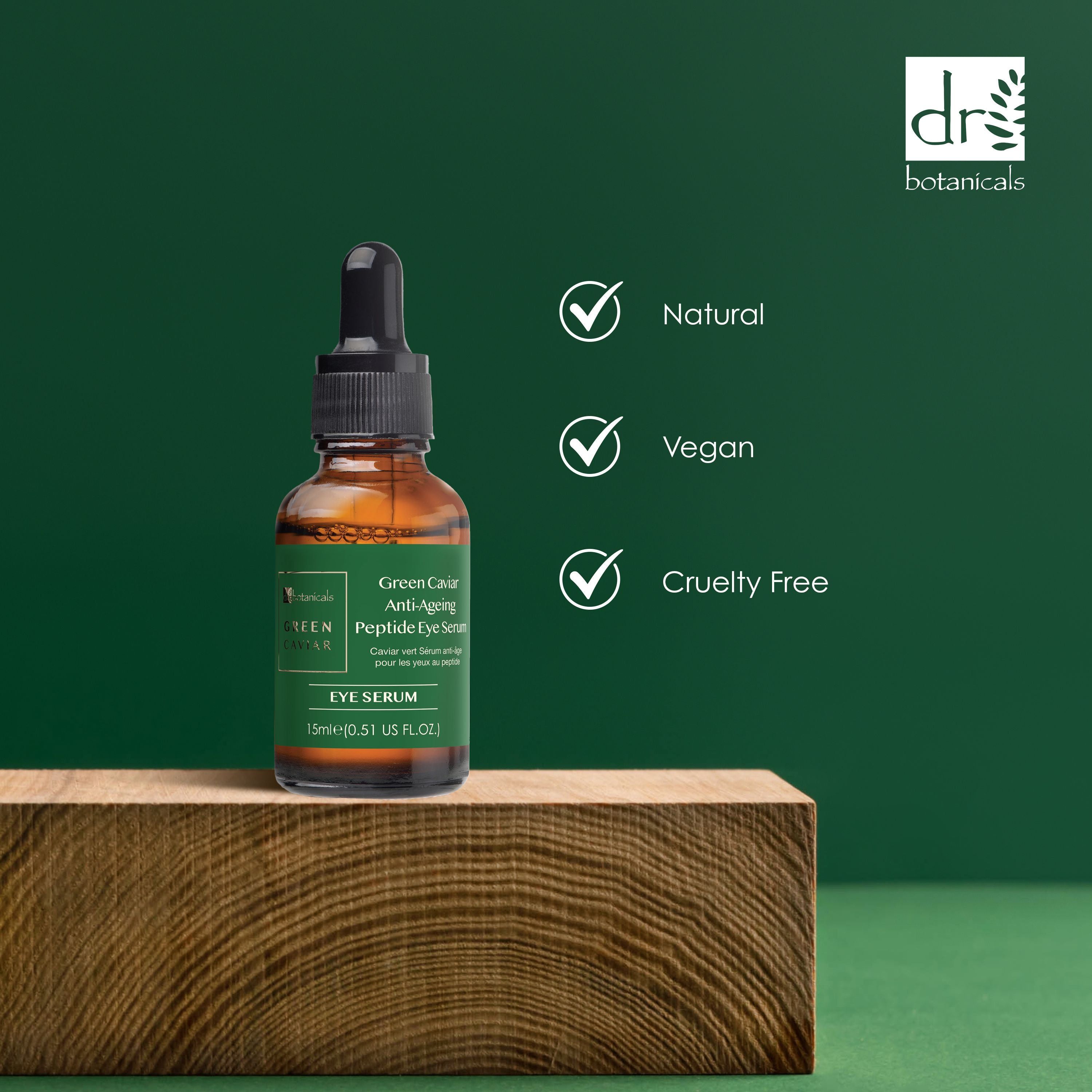 Braune Glasflasche mit schwarzer Pipette auf Holzblock. Logos: Natural, Vegan, Cruelty Free.
