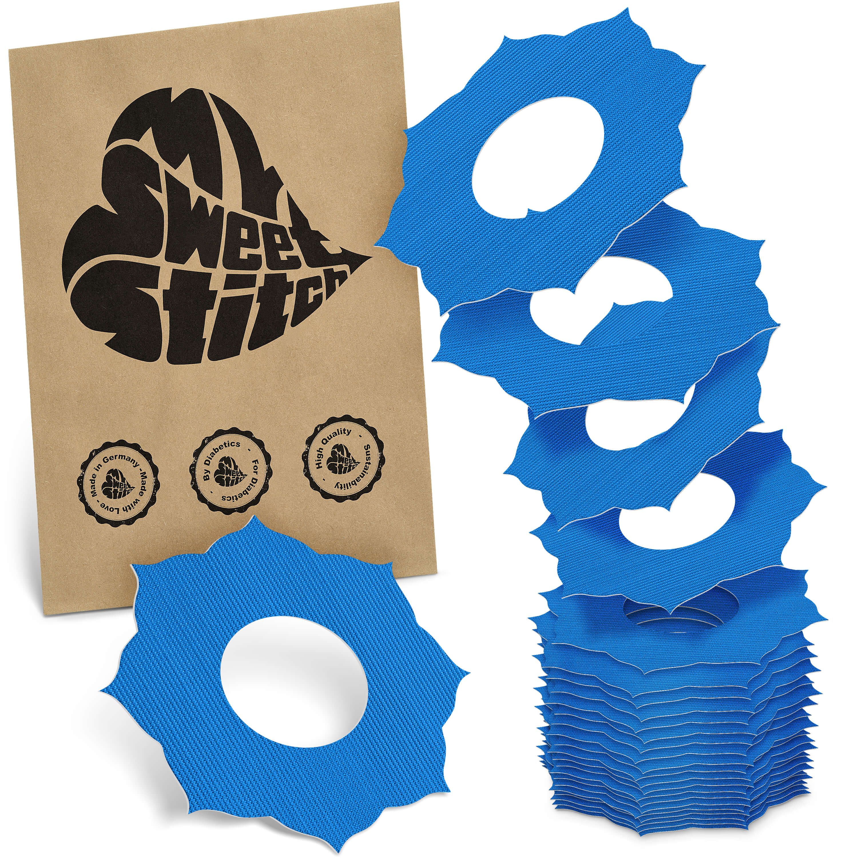 Blaue Fixierringe mit Loch, neben brauner Verpackung mit Logo und Siegeln. Stapel und einzelne Ringe sichtbar.