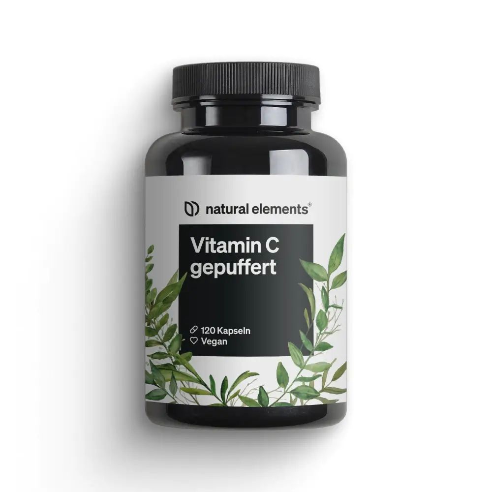 Schwarze Flasche mit weißem Etikett. Aufschrift: Vitamin C gepuffert, 120 Kapseln, Vegan. Pflanzliche Blätter als Dekoration.