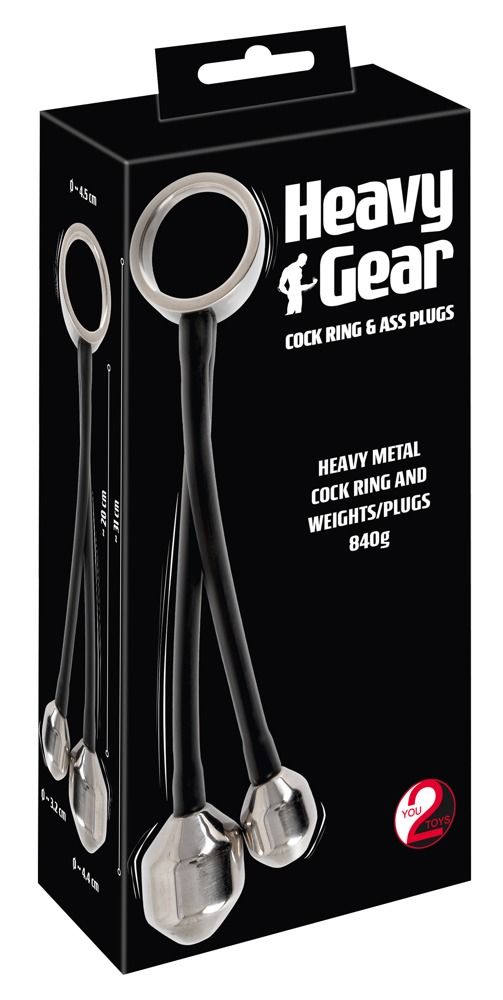 Verpackung mit Produkt: Metallring, zwei Gewichte, schwarze Verbindungen. Text: Heavy Gear, Cock Ring & Ass Plugs, You2Toys.