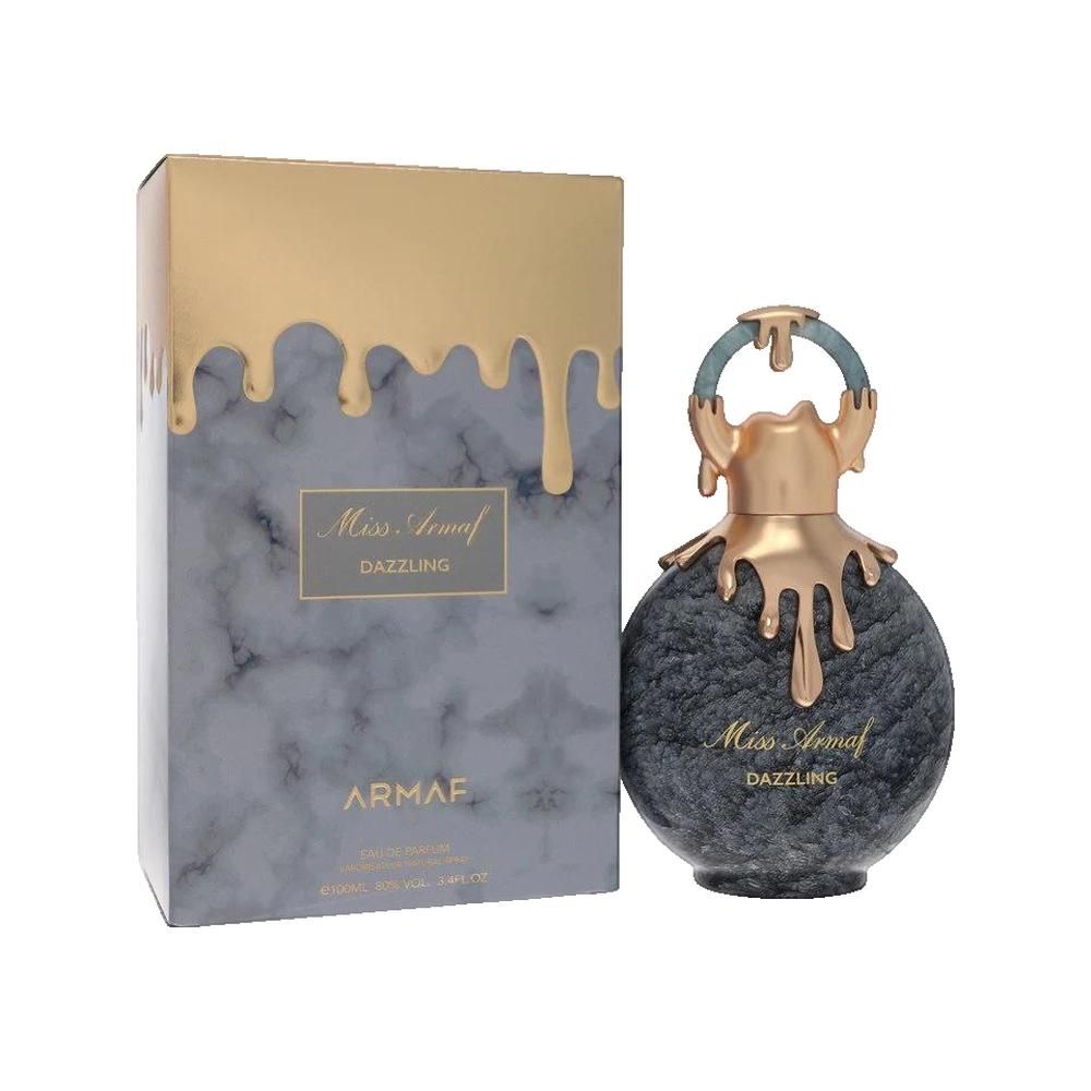 Parfümflakon und Schachtel. Flakon rund, grau marmoriert, goldfarbene Elemente. Schachtel marmoriert, goldfarbener Aufsatz. Schriftzug: Miss Armaf Dazzling.