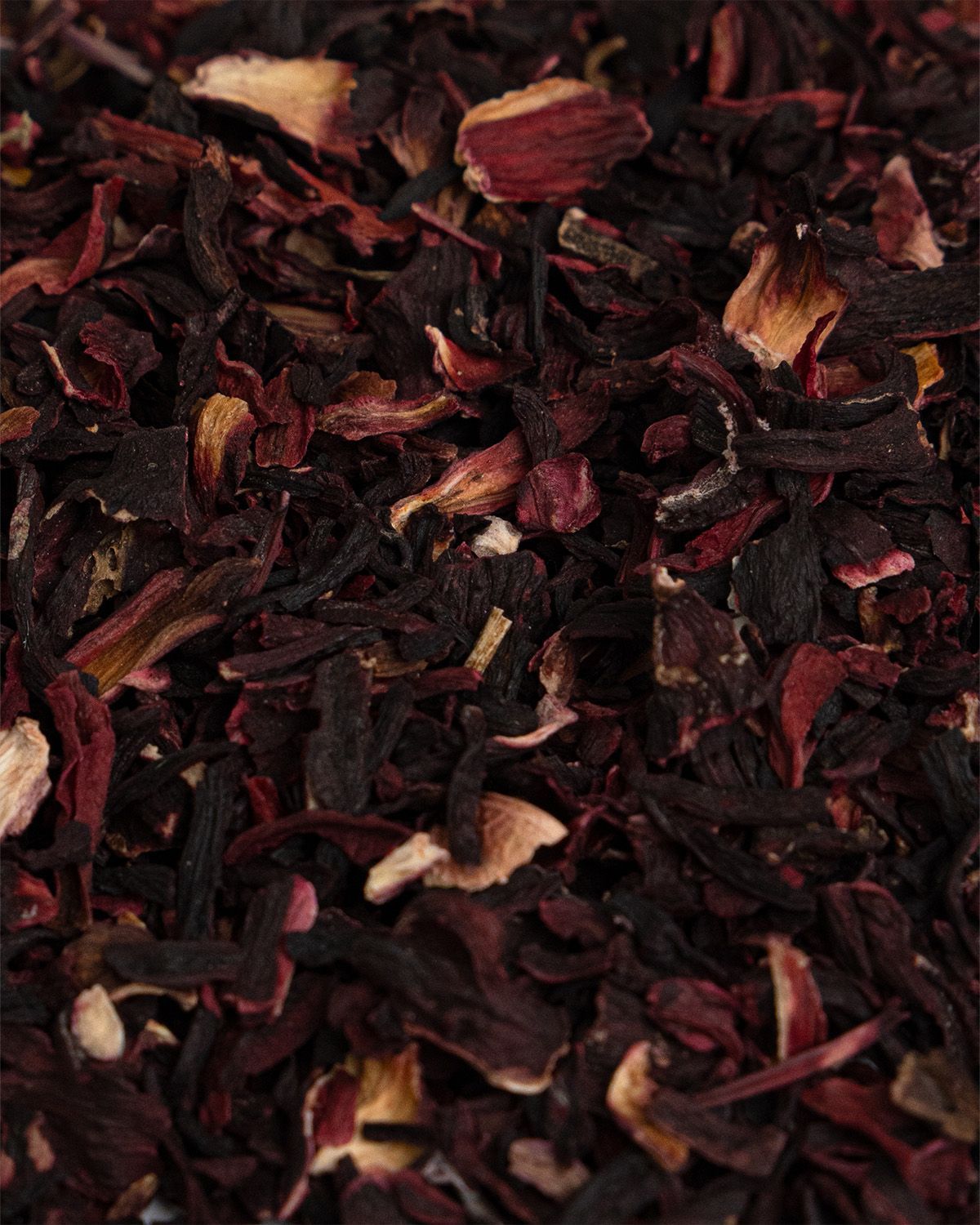 Nahaufnahme von getrockneten Hibiskusblüten. Rote und braune Blütenblätter. Detailreiche Textur.