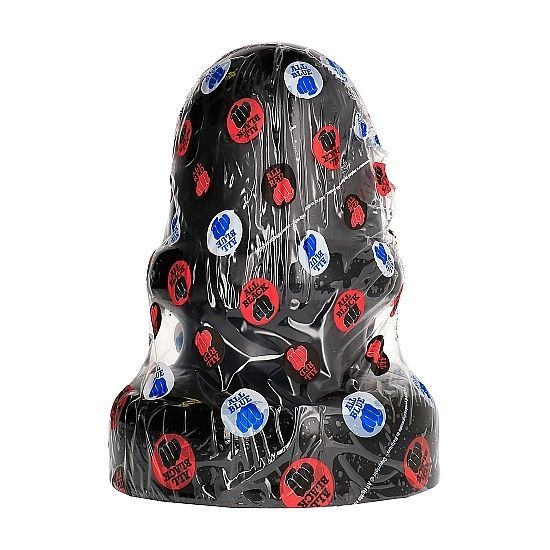 Schwarzer Analplug in transparenter Verpackung. Verpackung mit Aufklebern in Rot, Blau und Weiß.