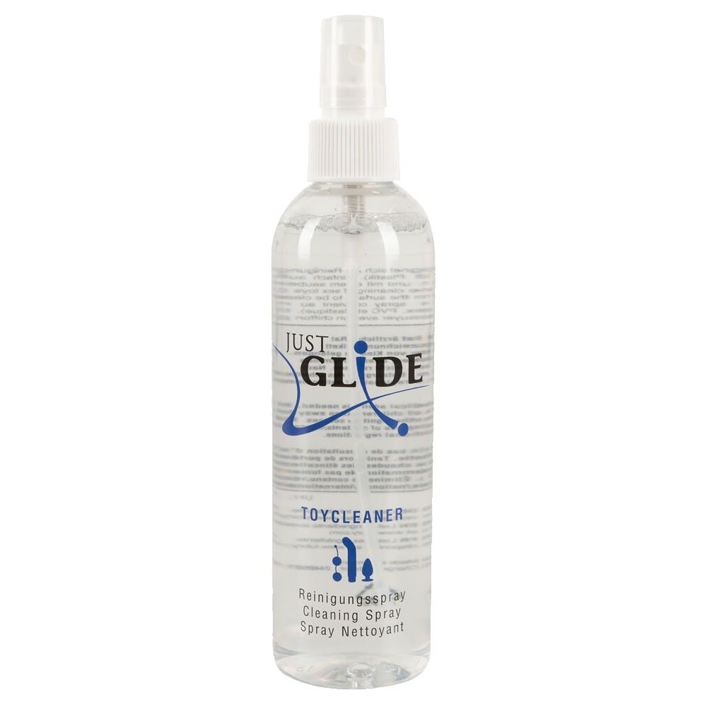 Transparente Sprühflasche mit weißem Sprühkopf. Aufschrift "JUST GLIDE TOYCLEANER". Mehrsprachige Beschriftung.