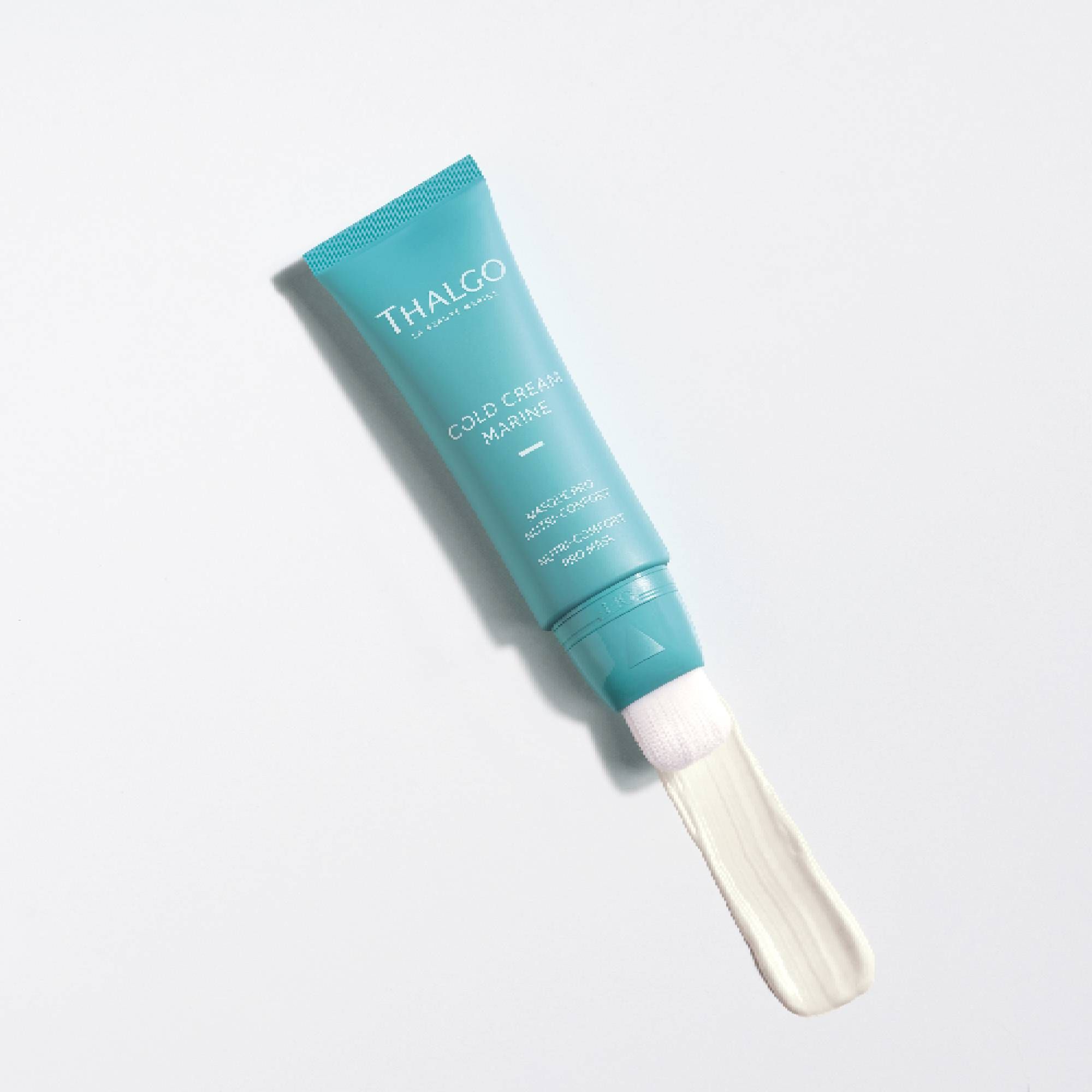 Türkisfarbene Tube, aus der Creme austritt. Aufschrift: THALGO, Cold Cream Marine, Masque Pro Nutri-Confort, Nutri-Comfort Pro Mask.