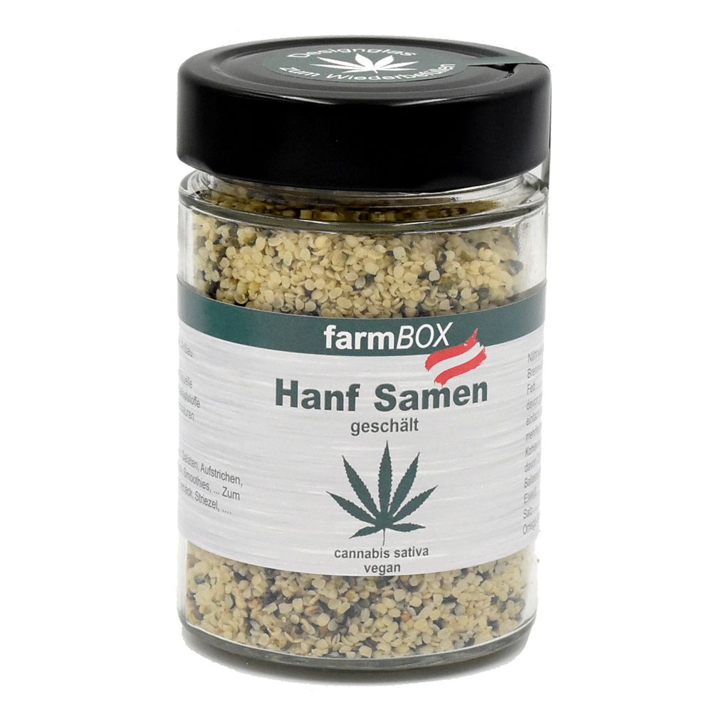 Glas mit Hanfsamen. Schwarzer Deckel, grünes Etikett mit Logo und Schriftzug. "Hanf Samen" und Cannabis-Blatt abgebildet.