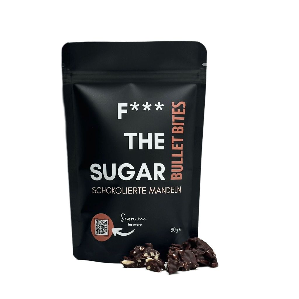 Schwarzer Beutel "F*** THE SUGAR" mit Schoko-Mandeln. Aufschrift: Bullet Bites. QR-Code. Einige Schoko-Mandeln daneben.