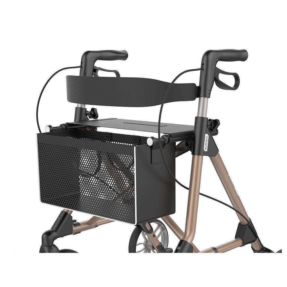 Nahaufnahme eines Rollators. Champagnerfarbener Rahmen, schwarzer Sitz und Korb. Räder teilweise sichtbar.