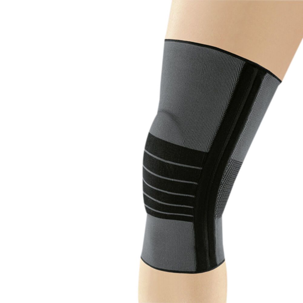 Kniebandage JuzoFlex® Genu 500, grau mit schwarzen Akzenten. Elastisches Material, Klettverschlüsse. Auf einem Bein getragen.
