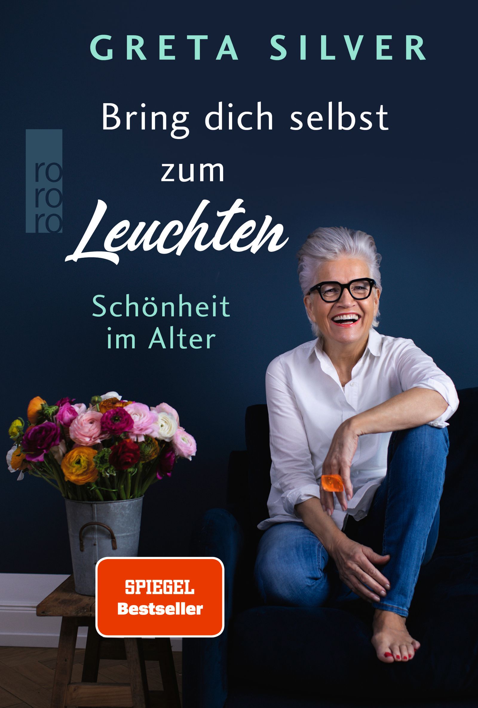 Buchcover: "Bring dich selbst zum Leuchten". Autorin Greta Silver, Frau mit Brille, Blumenstrauß.