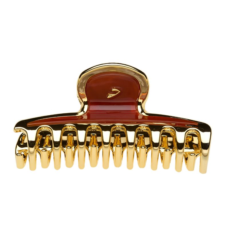 Haarspange in Goldoptik mit braunem Einsatz. Mehrere Zähne zum Greifen. Oberteil mit V-förmigem Detail.