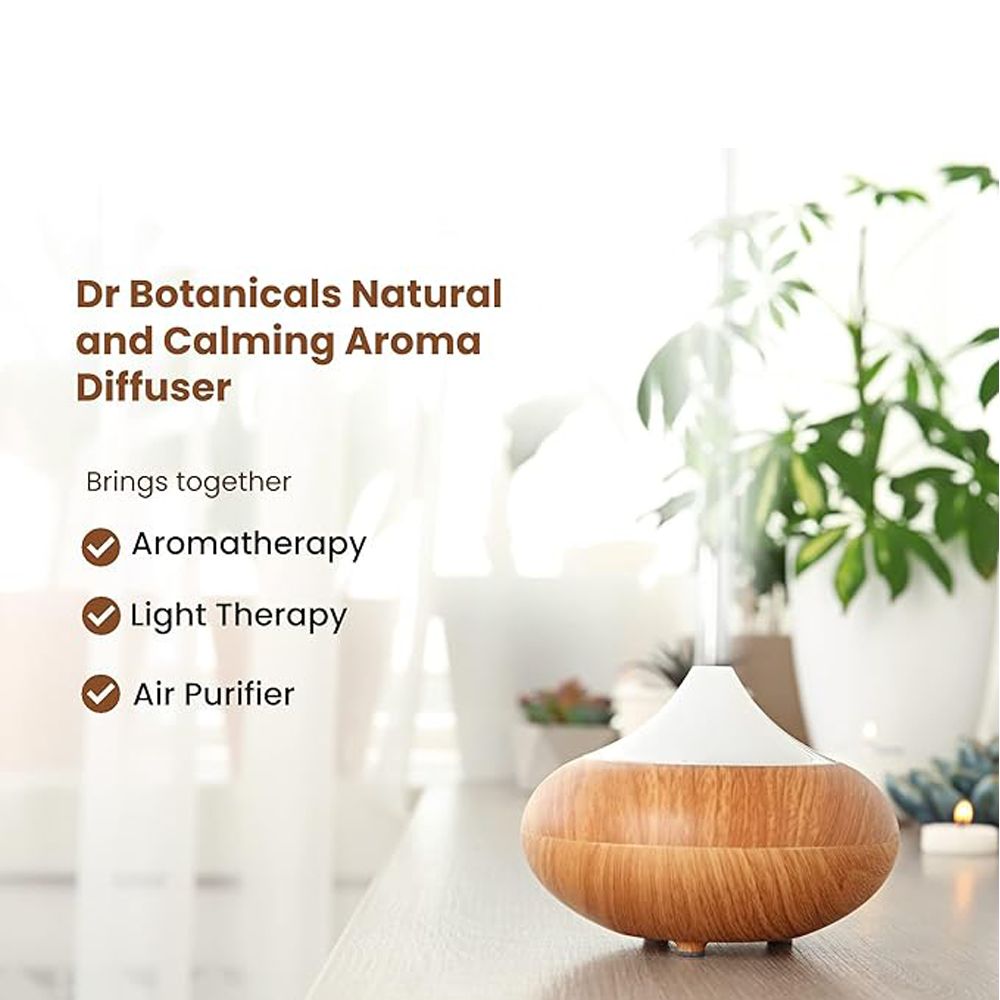 Aroma-Diffusor mit Holzmaserung und hellem Deckel. Text: Dr Botanicals. Aromatherapie, Lichttherapie, Luftreiniger.