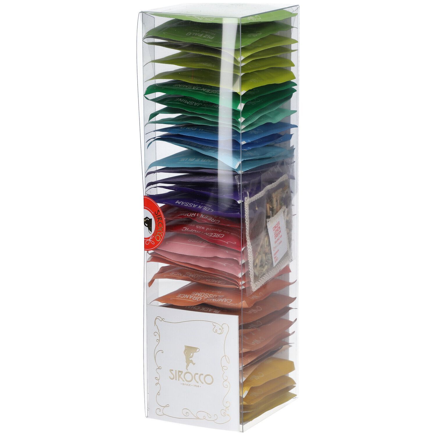 Hohe, transparente Box mit farbigen Teebeuteln. Logo auf der Vorderseite. Rotes Siegel. Teebeutel in verschiedenen Farben angeordnet.