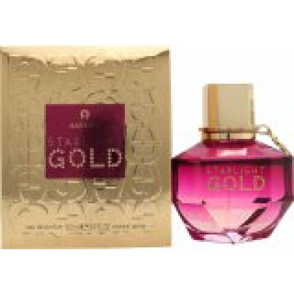 Parfümflakon und Schachtel. Flakon mit goldener Kappe und pinkfarbenem Inhalt. Aufschrift: Starlight Gold. Goldene Schachtel mit Logo.